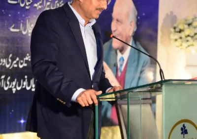 Host addressing guests at An Evening With Anwar Masood event